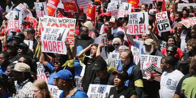 OAK BROOK, IL - MAY 21: Fast food workers and activists demonstrate outside the McDonald's corporate campus on May 21, 2014 in Oak Brook, Illinois. The demonstrators were calling on McDonald's to pay a minimum wage of $15-per-hour and offer better working conditions for their employees. Several protestors were arrested after they entered and ignored police orders to leave the McDonald's campus. McDonald's is scheduled to hold its annual shareholder's meeting tomorrow at the campus. (Photo by Scott Olson/Getty Images)