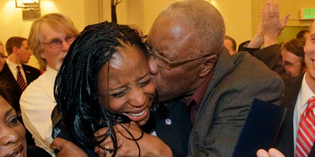 Republican Mia Love celebrates with her father, Jean Maxime Bourdeau, after winning the race for Utah's 4th Congressional District during the Utah State GOP election night watch party, Tuesday, Nov. 4, 2014, in Salt Lake City. (AP Photo/Rick Bowmer)