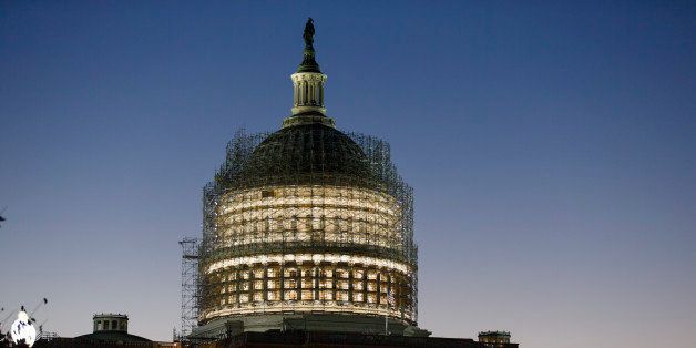 The Capitol Dome is nearly obscured by scaffolding at dawn in Washington, Friday, Oct. 24, 2014, for a long-term repair project to fix cracks, leaks and corrosion in the cast-iron structure. The House and Senate are adjourned until after the midterm election. (AP Photo/J. Scott Applewhite)