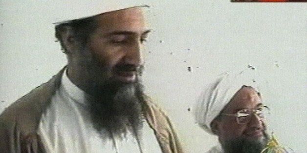 This image taken from video released by Qatar's Al-Jazeera televison broadcast on Friday Oct. 5, 2001 is said to show Osama bin Laden, the prime suspect in the Sept. 11, 2001 terrorist attacks on the United States, at an undisclosed location. Al-Jazeera did not say whether the image was taken before or after the Sept. 11 attacks or how they obtained it. At right is bin Laden's top lieutenant, Egyptian Ayman al-Zawahri. Bin Laden is believed to have been at a celebration of the union of his al-Qaida network and al-Zawahri's Egyptian Jihad group. Graphic at top right reads "Exclusive to Al-Jazeera." At bottom right is the station's logo which reads "Al-Jazeera." (AP Photo/Al-Jazeera via APTN)