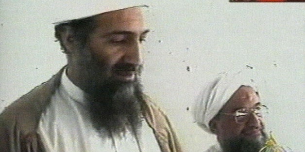 This image taken from video released by Qatar's Al-Jazeera televison broadcast on Friday Oct. 5, 2001 is said to show Osama bin Laden, the prime suspect in the Sept. 11, 2001 terrorist attacks on the United States, at an undisclosed location. Al-Jazeera did not say whether the image was taken before or after the Sept. 11 attacks or how they obtained it. At right is bin Laden's top lieutenant, Egyptian Ayman al-Zawahri. Bin Laden is believed to have been at a celebration of the union of his al-Qaida network and al-Zawahri's Egyptian Jihad group. Graphic at top right reads "Exclusive to Al-Jazeera." At bottom right is the station's logo which reads "Al-Jazeera." (AP Photo/Al-Jazeera via APTN)