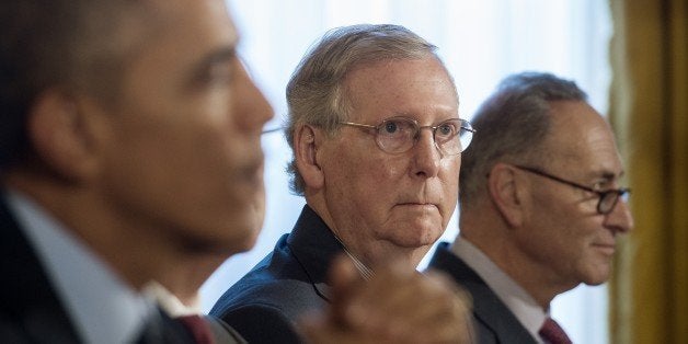 Senate Minority Leader Mitch McConnell, R-Kentucky (C), and US Senator Chuck Schumer(R), D-New York, look on as US President Barack Obama (L) speaks during a bipartisan, bicameral congressional leadership luncheon at the White House in Washington, DC, November 7, 2014. AFP PHOTO / Jim WATSON (Photo credit should read JIM WATSON/AFP/Getty Images)