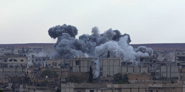 SANLIURFA, TURKEY - OCTOBER 31: A photograph taken from Suruc district of Sanliurfa, Turkey, shows smoke rising from an explosion in the Syrian border town of Kobani (Ayn al-Arab) following a US-led coalition airstrike hits an Islamic State of Iraq and the Levant (ISIL) targets on October 31, 2014. (Photo by Sercan Kucuksahin/Anadolu Agency/Getty Images)