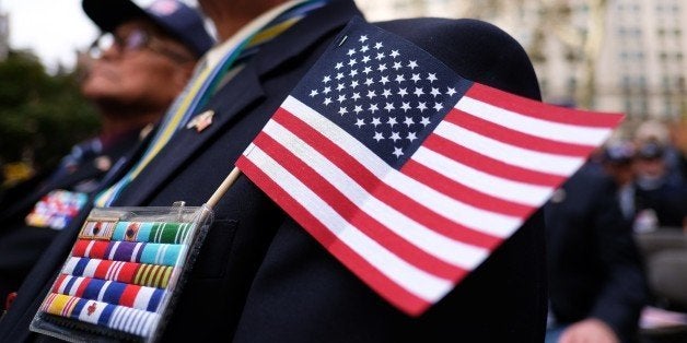 A US war veteran takes part in a memorial ceremony before the start of a Veterans Day Parade in New York on November 11, 2014