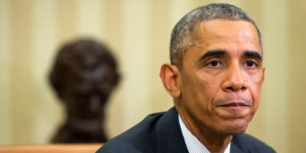 President Barack Obama pauses as he speaks to the media about the governmentâs Ebola response in the Oval Office of the Whi