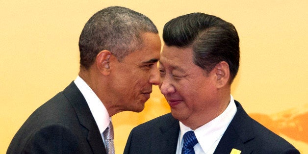 U.S. President Barack Obama, left, walks past Chinese President Xi Jinping during a welcome ceremony for the Asia-Pacific Economic Cooperation (APEC) summit at the International Convention Center in Yanqi Lake, Beijing, China Tuesday, Nov. 11, 2014. (AP Photo/Ng Han Guan)