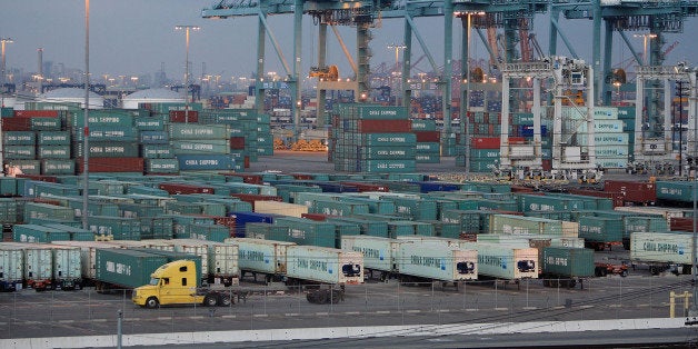 LONG BEACH, CA - SEPTEMBER 08: A truck passes shipping containers at China Shipping at the Ports of Long Beach and Los Angeles, the busiest port complex in the US, on September near Long Beach, California. The federal judge tentatively denied the largest trucking association, the American Trucking Association, from blocking the new anti-pollution measures for the ports set to take effect on October 1. The $1.6 billion Clean Trucks Program was developed after years of debate between drivers, city officials, and environmentalist. It targets toxic diesel emissions and bans all 16,800 pre-1989 trucks from the ports. The truckers sued the City of Los Angeles alleging that the program is unfair to truckers, favoring large trucking companies over smaller independent contractors who tend to drive older trucks. About 40 percent of US imports pass through the Los Angeles-Long Beach port complex. (Photo by David McNew/Getty Images)