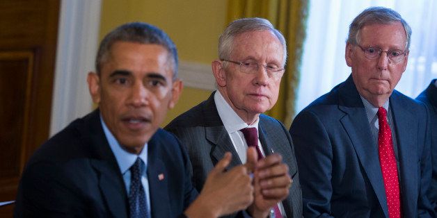 Senate Minority Leader Mitch McConnell of Ky., right, and Senate Majority Leader Harry Reid of Nev., center, listen as President Barack Obama speaks during a meeting with Congressional leaders in the Old Family Dining Room of the White House in Washington, Friday, Nov. 7, 2014. (AP Photo/Evan Vucci)