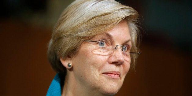 This photo taken June 25, 2014, shows Sen. Elizabeth Warren, D-Mass., questions Treasury Secretary Jacob Lew as he testifies