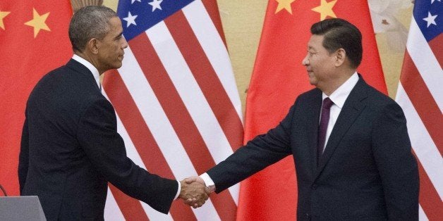 US President Barack Obama (L) and China's President Xi Jinping shake hands following a bilateral meeting at the Great Hall o