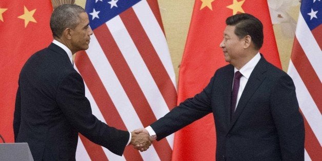 US President Barack Obama (L) and China's President Xi Jinping shake hands following a bilateral meeting at the Great Hall of the People in Beijing on November 12, 2014. Obama began a one-day state visit after the closing of the Asia-Pacific Economic Cooperation summit. AFP PHOTO / Mandel NGAN (Photo credit should read MANDEL NGAN/AFP/Getty Images)