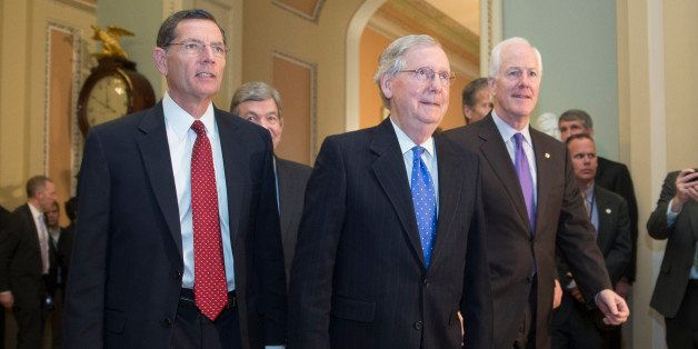 Senator John Barrasso, a Republican from Wyoming, from left, Senator Roy Blunt, a Republican from Missouri, Senate Minority Leader Mitch McConnell, a Republican from Kentucky, and Senator John Cornyn, a Republican from Texas, walk though the U.S. Capitol Building after holding a private meeting in Washington, D.C., U.S., on Thursday, Nov. 13, 2014. Mitch McConnell was re-elected as Senate Republican leader, moving a step closer to realizing his ambition to be Senate majority leader when his party assumes control of the chamber in January. Photographer: Andrew Harrer/Bloomberg via Getty Images 