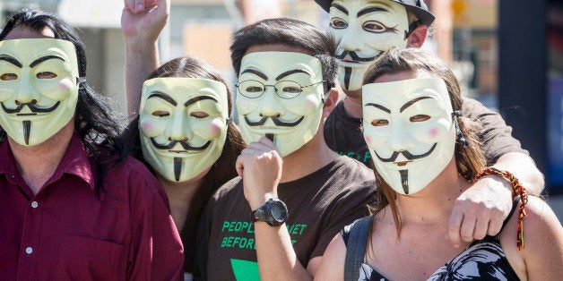 BRISBANE, AUSTRALIA - NOVEMBER 14: Anonymous activists meet in inner Brisbane wearing Guy Fawkes masks, an item that has been banned during the G20 Summit, ahead of the Peoples' March on November 14, 2014 in Brisbane, Australia. The Peoples' March is expected to be one of the largest protests during the summit. World leaders have gathered in Brisbane for the annual G20 Summit and are expected to discuss economic growth, free trade and climate change as well as pressing issues including the situation in Ukraine and the Ebola crisis. (Photo by Glenn Hunt/Getty Images)