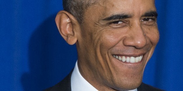 ALTERNATE CROP - US President Barack Obama smiles prior to signing an Executive Order to implement enhanced security measures on consumers' financial security following remarks at the Consumer Financial Protection Bureau (CFPB) in Washington, DC, October 17, 2014. The measures include plans to secure credit, debit and other payment cards with microchips, instead of magnetic strips, and assign PINs to each card. AFP PHOTO / Saul LOEB (Photo credit should read SAUL LOEB/AFP/Getty Images)