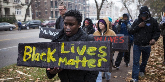 FERGUSON, MO - NOVEMBER 16: As the U.S. town of Ferguson, Missouri, awaits a grand jury decision on whether to bring criminal charges against a police officer who killed unarmed 18-year-old Michael Brown, protestors march through downtown on November 16,2014. (Photo by Samuel Corum/Anadolu Agency/Getty Images)