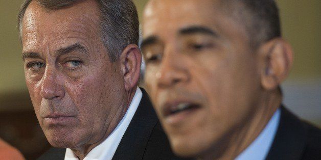 Speaker of the House John Boehner(L), R-OH looks on as US President Barack Obama speaks during a bipartisan, bicameral, congressional leadership luncheon at the White House in Washington, DC, November 7, 2014. AFP PHOTO / Jim WATSON (Photo credit should read JIM WATSON/AFP/Getty Images)