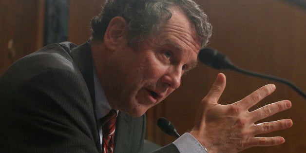 Sen. Sherrod Brown, D-Ohio, questions ousted IRS Chief Steve Miller, former IRS Commissioner Douglas Shulman, J. Russell George, Treasury Inspector General for Tax Administration, testify during a hearing at the Senate Finance Committee on the Internal Revenue Service (IRS) practice of targeting applicants for tax-exempt status based on political leanings on Capitol Hill, in Washington, Tuesday, May 21, 2013. (AP Photo/Charles Dharapak)