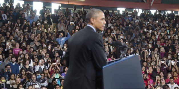 The crowd cheers as US President Barack Obama delivers remarks on the new steps he will be taking within his executive authority on immigration at Del Sol High School in Las Vegas, Nevada, November 21, 2014. AFP PHOTO / Jim WATSON (Photo credit should read JIM WATSON/AFP/Getty Images)