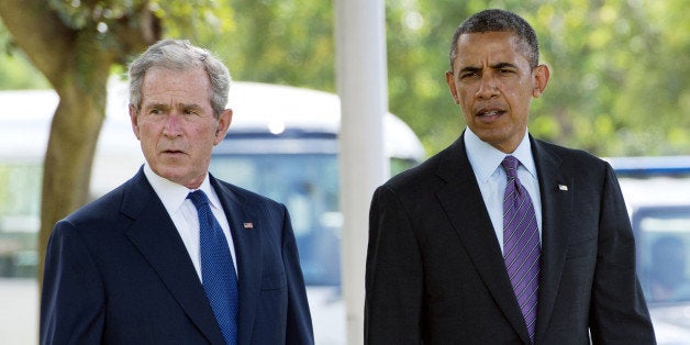 US President Barack Obama (R) and former US President George W. Bush arrive on July 2, 2013 for a wreath-laying ceremony for victims of the 1998 Embassy bombing at the Bombing Memorial at the US Embassy in Dar Es Salaam. Bush is in Tanzania for a forum of regional First Ladies, hosted by his wife Laura, which will also be attended by First Lady Michelle Obama.AFP PHOTO / Saul LOEB (Photo credit should read SAUL LOEB/AFP/Getty Images)