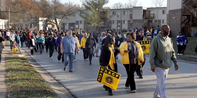 Hundreds march away from the area where Michael Brown was killed Saturday, Nov. 29, 2014, in Ferguson, Mo., at the start of a 120-mile march to the governor's mansion in Jefferson City. The march, organized by the NAACP to evoke civil rights marches from the 1960s, began Saturday afternoon on Canfield Drive in Ferguson where Michael Brown was killed and is expected to last seven days. (AP Photo/Jeff Roberson)