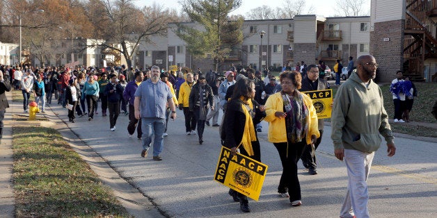 Hundreds march away from the area where Michael Brown was killed Saturday, Nov. 29, 2014, in Ferguson, Mo., at the start of a
