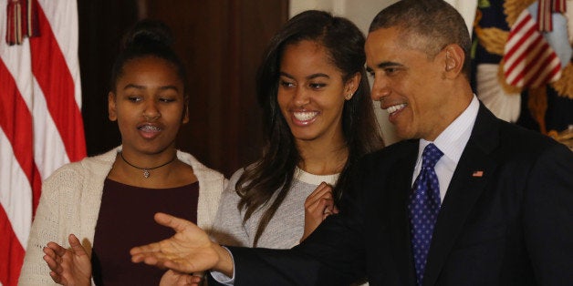 WASHINGTON, DC - NOVEMBER 26: U.S. President Barack Obama (R) speaks as his daughters Sasha (L) and Malia (R) look on after pardoning 'Cheese' and his alternate Mac both, 20-week old 48-pound Turkeys, during a ceremony at the White House November 26, 2014 in Washington, DC. The Presidential pardon of a turkey has been a long time Thanksgiving tradition that dates back to the Harry Truman administration.(Photo by Mark Wilson/Getty Images)