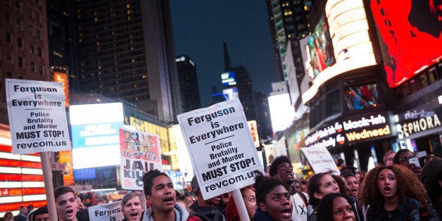 NEW YORK, NY - DECEMBER 01: People rally in Times Square after marching through the streets in protest to the Ferguson grand jury decision to not indict officer Darren Wilson in the Michael Brown case on December 1, 2014 in New York City. Several peple were arrested throughout the protest. Brown, an 18-year-old black man, was killed by Darren Wilson, a white Ferguson, MO police officer, on August 9. (Photo by Andrew Burton/Getty Images)