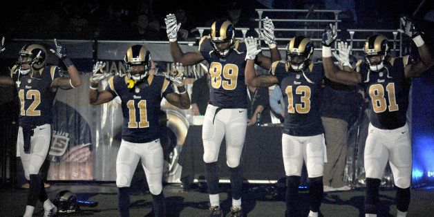 FILE - In this Sunday Nov. 30, 2014, file photo, St. Louis Rams players, from left; Stedman Bailey (12), Tavon Austin (11), Jared Cook, (89) Chris Givens (13) and Kenny Britt (81) raise their arms in awareness of the events in Ferguson, Mo., as they walk onto the field during introductions before an NFL football game against the Oakland Raiders in St. Louis. Time will tell whether the ``hands-up'' gesture during pregame introductions will leave a lasting memory or simply go down as a come-and-go moment in the age of the 24-hour news cycle. Either way, it certainly isn't the first time high-profile athletes have used their platform to make political statements. (AP Photo/L.G. Patterson, File)