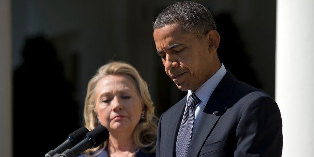President Barack Obama, accompanied by Secretary of State Hillary Rodham Clinton, speaks about the death of U.S. ambassador to Libya Christopher Stevens, Wednesday, Sept. 12, 2012, in the Rose Garden of the White House in Washington. (AP Photo/Evan Vucci)