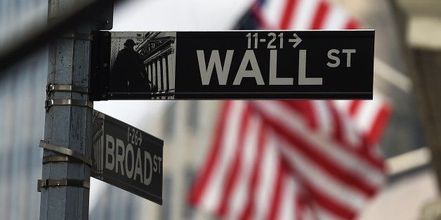 A Wall Street road sign is pictured near the New York Stock Exchange (NYSE) building on October 16, 2014 in New York. US stocks dropped sharply in early trade Thursday, following international markets downward as anxiety over global growth continued to prompt selling. About 30 minutes into trade, the Dow Jones Industrial Average stood at 16,062.34, down 79.40 points (0.49 percent). AFP PHOTO/Jewel Samad (Photo credit should read JEWEL SAMAD/AFP/Getty Images)