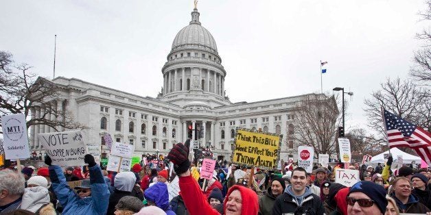 Protesters march outside the state Capitol Saturday, March 12, 2011, in Madison, Wis. While Gov. Scott Walker has already signed a contentious collective bargaining bill into law, demonstrators insist the fight is not over. For some, the focus has shifted from trying to stop passage of the bill to generating momentum for recall efforts against Republicans. Others are simply venting their frustration over the law taking away most of public workers' collective bargaining rights. (AP Photo/Morry Gash)