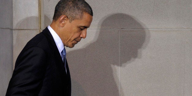 President Barack Obama casts a shadow as he walks off of the stage after speaking at the 2012 Tribal...