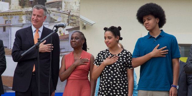 GRASSANO, ITALY - JULY 24: New York City Mayor Bill de Blasio, Chirlane McCray, Chiara de Blasio and Dante de Blasio stand for the national anthem at a welcome ceremony during a visit to Mayor de Blasio's grandmother's town on July 24, 2014 in Grassano, Italy. The New York City mayor and his family are on an eight-day holiday in Italy but de Blasio has plans to meet with Italy's foreign minister, Federica Mogherini, and with Pietro Parolin, the Holy Sees secretary of state. (Photo by Giovanni Marino/Getty Images)