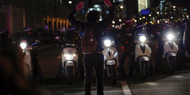 NEW YORK, NY - DECEMBER 4: Demonstrators watched by New York City police block the West Side Highway following yesterday's decision by a Staten Island grand jury not to indict a police officer who used a chokehold in the death of Eric Garner in July, on December 4, 2014 in New York City. The grand jury declined to indict New York City Police Officer Daniel Pantaleo in Garner's death. (Photo by Kena Betancur/Getty Images)