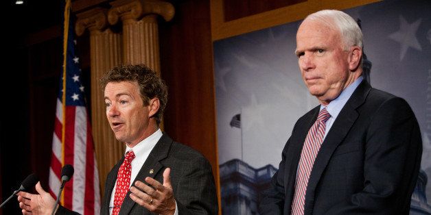 WASHINGTON - OCTOBER 13: U.S. Sen. Rand Paul (R-KY) (L) speaks as Sen. John McCain (R-AZ) looks on at a news conference on Capitol Hill to introduce a Republican jobs proposal to compete with that put forward by President Obama on October 13, 2011 in Washington, DC. The legislation targets the tax code, spending, and regulation in an attempt to grow the private sector. (Photo by Brendan Hoffman/Getty Images)