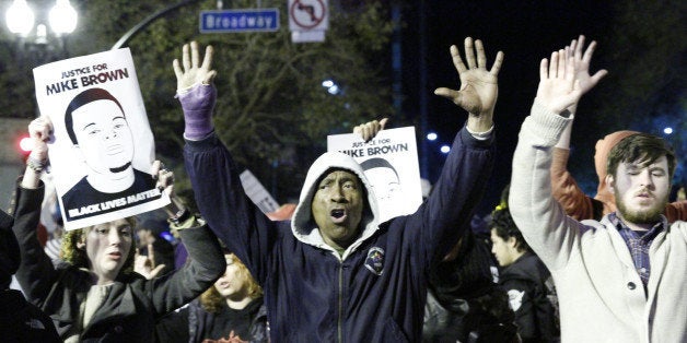 OAKLAND, CA - NOVEMBER 24: Thousands of people protesting the grand jurys decision about the fatal police shooting of black 18-year old Michael Brown in Ferguson, Missouri march onto the lanes of Interstate 580 after blocking the traffic for several hours near Lakeshore Avenue in Oakland, United States on November 24, 2014. (Photo by Tayfun Coskun/Anadolu Agency/Getty Images)