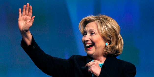 Former Secretary of State Hillary Rodham Clinton waves as she is introduced to speak at the Massachusetts Conference for Women in Boston, Thursday, Dec. 4, 2014. (AP Photo/Elise Amendola)