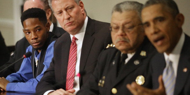 WASHINGTON, DC - DECEMBER 01: Ferguson, Missouri resident Rasheen Aldridge (L) listens to U.S. President Barack Obama (R) at the conclusion of a meeting with New York Mayor Bill de Blasio, Philadelphia Police Department Commissioner Charles Ramsey and other elected officials, community and faith leaders and law enforcement officials in the Eisenhower Executive Office Building December 1, 2014 in Washington, DC. After the recent civil unrest in Ferguson and across the country in the wake of the shooting of unarmed teenager Michael Brown and the lack of charges against the police officer who shot him, Obama discussed ways for 'communities and law enforcement can work together to build trust to strengthen neighborhoods across the country.' (Photo by Chip Somodevilla/Getty Images)