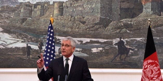 US Secretary of Defense Chuck Hagel speaks during a joint press conference with Afghan President Ashraf Ghani at the Presidential Palace in Kabul on December 6, 2014. An additional 1,000 US troops will remain in Afghanistan next year to meet a temporary shortfall in NATO forces, US Defense Secretary Chuck Hagel said December 6 during a visit to Kabul. AFP PHOTO/WAKIL KOHSAR (Photo credit should read WAKIL KOHSAR/AFP/Getty Images)