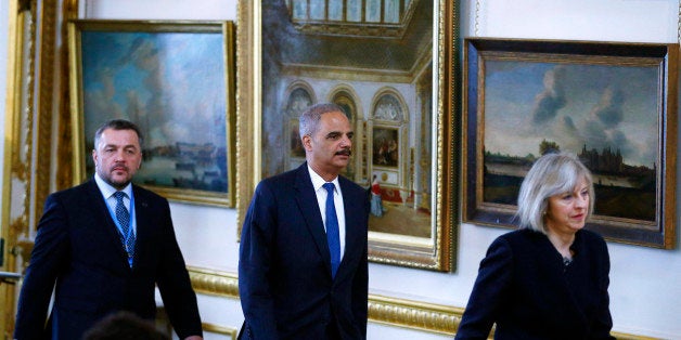 Ukraine's general prosecutor Oleh Makhnitskyi, left, U.S. Attorney General Eric Holder and Britain's Home Secretary Theresa May arrive to open the Ukraine Forum on Asset Recovery in central London, Tuesday April 29, 2014. Britain and the United States are co-hosting the two-day "asset recovery forum" designed to help find and recover assets believed to have been stolen by the regime of ousted Ukrainian president Viktor Yanukovych. (AP Photo/Andrew Winning, Pool)