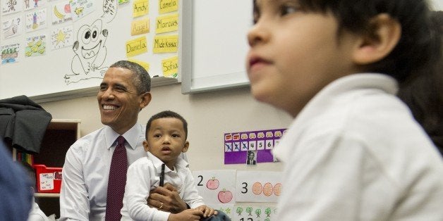 Marcus Wesby sits on the lap of US President Barack Obama as he tours a Pre-K classroom at Powell Elementary School prior to speaking on the Fiscal Year 2015 budget in Washington, DC, March 4, 2014.The White House projected a steady fall in the US deficit over the next decade while the economy grows moderately, as it released its budget for the 2015 fiscal year on Tuesday. The budget foresees the American economy growing by 3.1 percent this year and by 3.4 percent the next, with inflation remaining under control, rising to only 2.0 percent in 2015.AFP PHOTO / Saul LOEB (Photo credit should read SAUL LOEB/AFP/Getty Images)