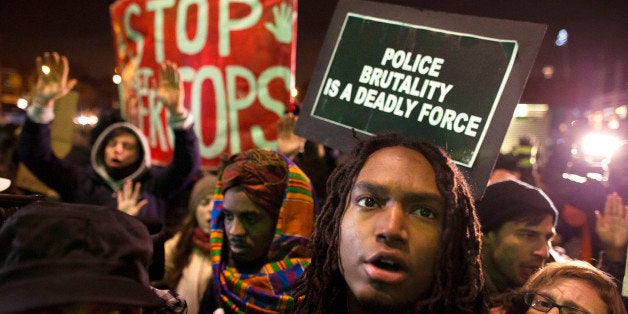 Protestors rally outside the Barclays Center against a grand jury's decision not to indict the police officer involved in the death of Eric Garner, Monday, Dec. 8, 2014, in the Brooklyn borough of New York. Britain's Prince William, the Duke of Cambridge, and Kate, Duchess of Cambridge, not pictured, attended a NBA basketball game between the Cleveland Cavaliers and the Brooklyn Nets at Barclays Center. (AP Photo/John Minchillo)