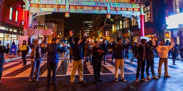 WASHINGTON, DC - DECEMBER 5 : Protesters demonstrate on the streets of Washington during a protest after two grand juries decided not to indict the police officers involved in the deaths of Michael Brown in Ferguson, Mo. and Eric Garner in New York, N.Y. in Washington, D.C. on December 5, 2014. (Photo by Samuel Corum/Anadolu Agency/Getty Images)