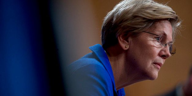 Senator Elizabeth Warren, a Democrat from Massachusetts, listens during a Senate Banking Subcommittee hearing with William C. Dudley, president and chief executive officer of the Federal Reserve Bank of New York, not pictured, in Washington, D.C., U.S., on Friday, Nov. 21, 2014. Dudley said in testimony he vowed to improve bank supervision and regulation, saying he's aware of the risk of becoming too cozy with large financial firms. Photographer: Andrew Harrer/Bloomberg via Getty Images 