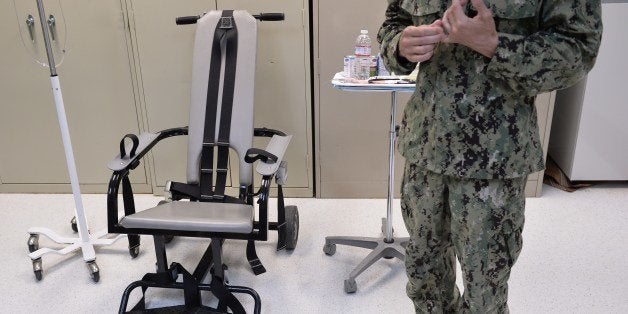 This photo reviewed by the US military and made during an escorted visit shows a US naval medic explaining the 'feeding chair