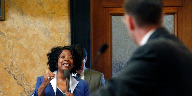 House Judiciary Committee B chairman Andy Gipson, R-Braxton, right, listens to Rep. Omeria Scott, D-Laurel question the intent of the Mississippi Religious Freedom Restoration Act in House chambers at the Capitol in Jackson, Miss., Wednesday, March 12, 2014. The House passed Senate Bill 2681 by an 80-37 vote Wednesday after it had been amended to call for a study panel of the combined House and Senate Judiciary committees. Another prong that inserts the phrase "In God We Trust" into the state seal passed intact. Lawmakers in both chambers are trying to meet a deadline for floor action on bill originating in the other house. (AP Photo/Rogelio V. Solis)