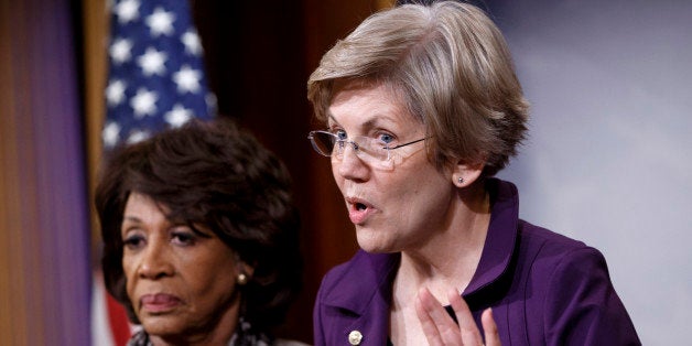 CORRECTS TO APPROVED, NOT PASSED - Sen. Elizabeth Warren, D-Mass., a member of the Senate Banking Committee, right, and Rep. Maxine Waters, D-Calif., ranking member of the House Financial Services Committee, express their outrage to reporters that a huge, $1.1 trillion spending bill approved by the Republican-controlled House yesterday contains changes to the 2010 Dodd-Frank law that regulates complex financial instruments known as derivatives, Wednesday, Dec. 10, 2014, on Capitol Hill in Washington. Democratic support for the omnibus bill funding every corner of government faded Wednesday as liberal lawmakers erupted over a provision that weakens the regulation of risky financial instruments and another that allows more money to flood into political parties. (AP Photo/J. Scott Applewhite)