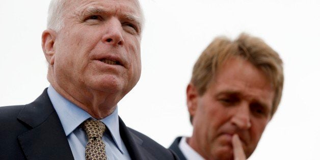 FILE - Sen. John McCain, left, R-AZ, and Sen. Jeff Flake, R-AZ, hold a news conference to discuss recent reports that dozens of VA hospital patients in Arizona may have died while awaiting medical care in the Phoenix VA Health Care System, adjacent to the VA Hospital in this Friday, April 18, 2014 file photo taken in Phoenix. Growing concerns about allegations of gross mismanagement and neglect at the Phoenix VA Health Care Center have resulted in a commitment by the chairman of the Senate Veterans' Affairs Committee to hold a hearing, members of Arizona's congressional delegation said Thursday April 24, 2014. (AP Photo/Ross D. Franklin, File)