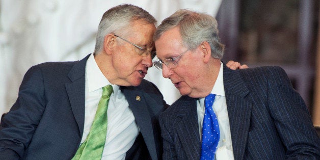 UNITED STATES - DECEMBER 10: Senate Majority Leader Harry Reid, D-Nev., left, and Minority Leader Mitch McConnell, R-Ky., talk during a Congressional Gold Medal ceremony for the Civil Air Patrol in the Capitol Visitor Center's Emancipation Hall, December 10, 2014. (Photo By Tom Williams/CQ Roll Call)