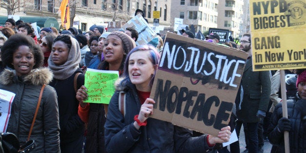 NEW YORK, NY - DECEMBER 13: Thousands of protestors converge on Manhattan's Washington Square Park to march through the Manhattan to protest the police violence on December 13, 2014 in New York, United States. Protestors shout slogans as Hands up, dont shoot, Black lives matter and I cant breathe during the march. (Photo by Mustafa Caglayan/Anadolu Agency/Getty Images)